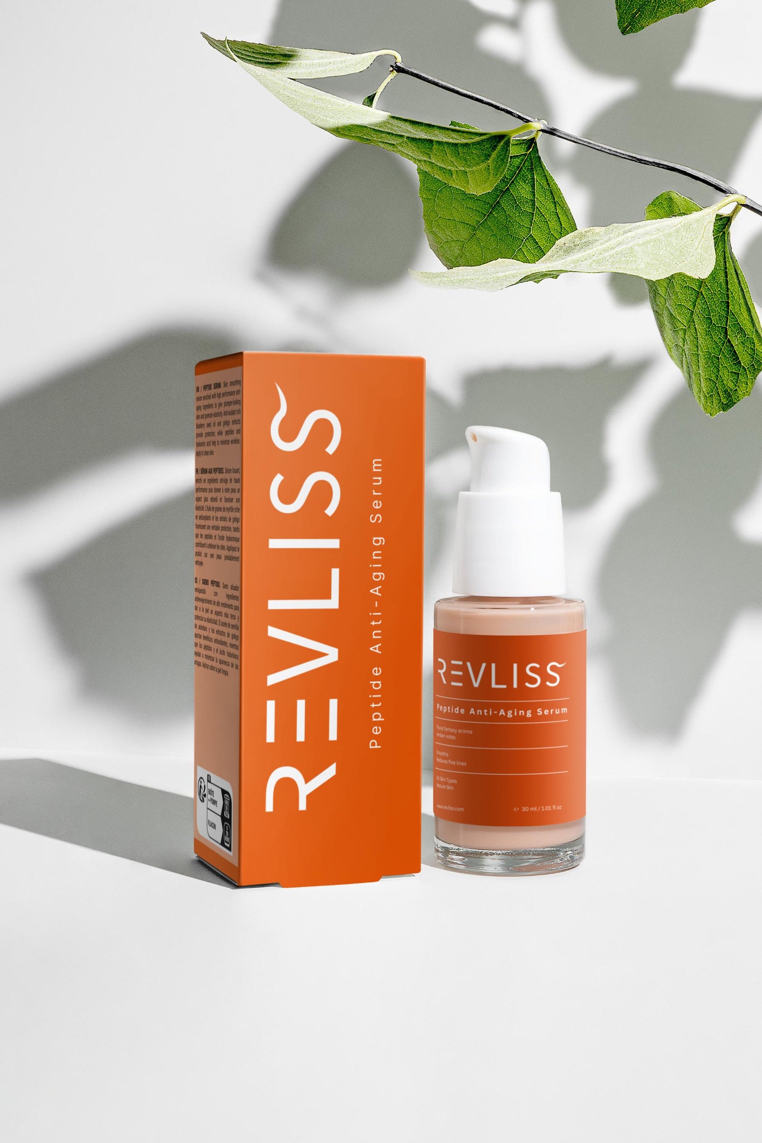 Revliss Peptide Serum bottle and packaging with green leaves on a light background
