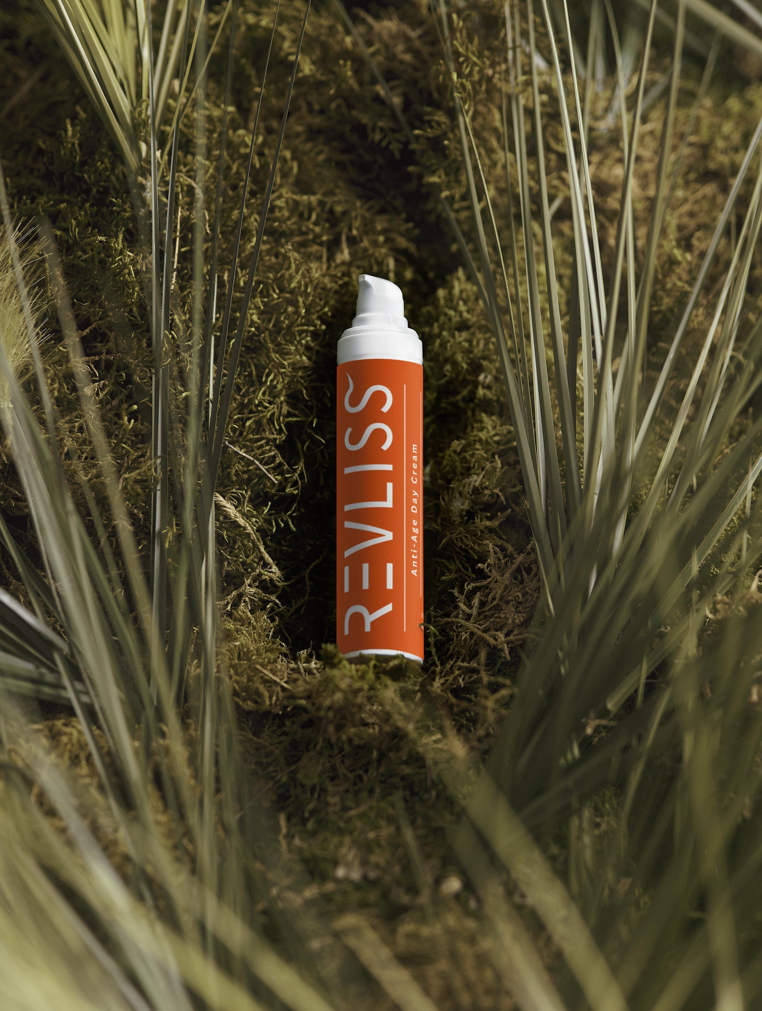 Revliss product in a natural setting with grass and moss