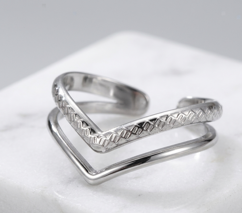 Two silver rings stacked on a light gray surface