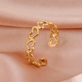 Gold hoop earring on a soft pink fabric background