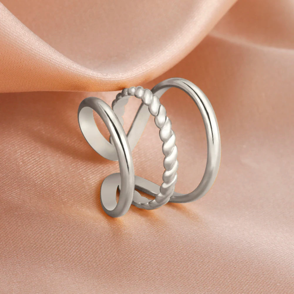  silver ring on a soft pink fabric background